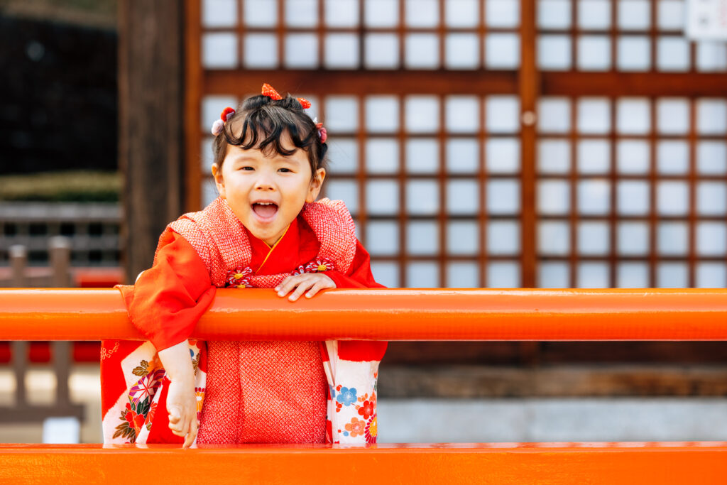 七五三のお参りの神社で笑顔を向けている女の子の写真